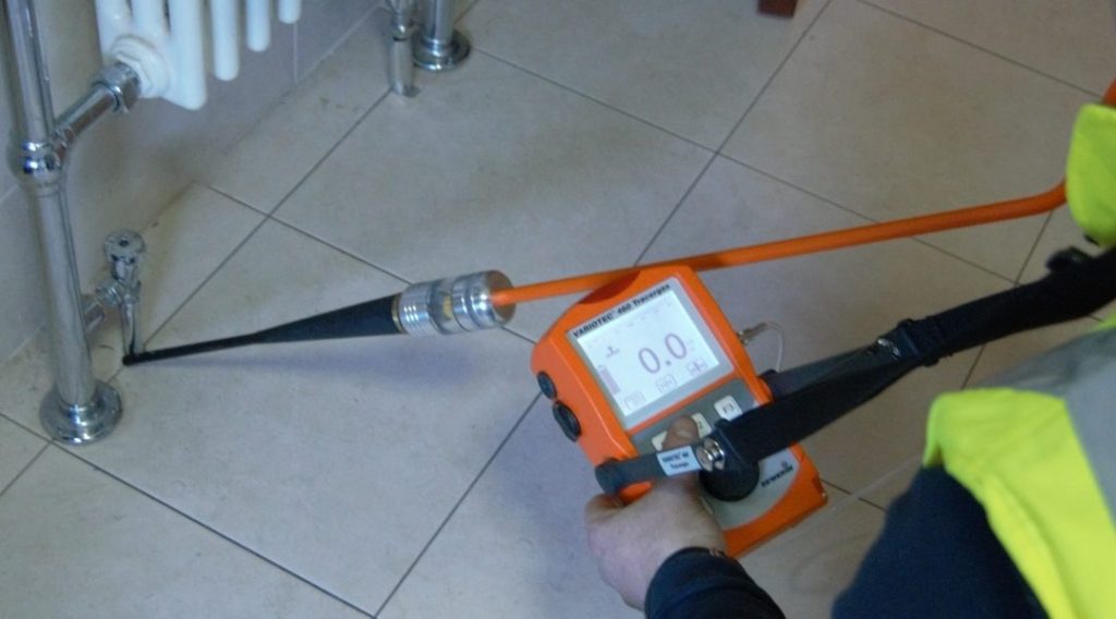 Professional technician checking water leakage